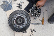 Close up on disassembling differential vehicle part during repair gear axle assembly