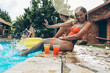 © BalanceFormCreative - Friends are having fun and playing in the swimming pool.They are smiling and joying on a hot summer day.