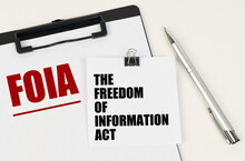 On the tablet, a sheet of paper and stickers with the inscription - FOIA, THE FREEDOM OF INFORMATION ACT