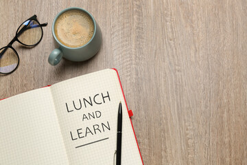 Lunch and Learn concept. Notebook, cup of coffee and glasses on wooden table, flat lay