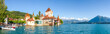 canvas print picture - Blick auf Schloss Oberhofen vom Steg aus, mit Eiger Mönch und Jungfrau im Hintergrund und dem Thuner See, Schweiz 