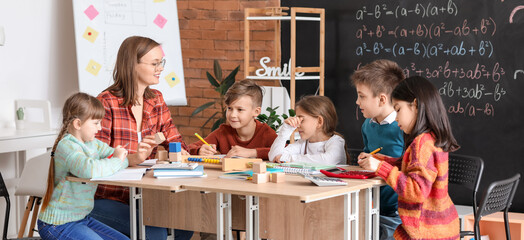 Sticker - Children with math teacher during lesson in classroom