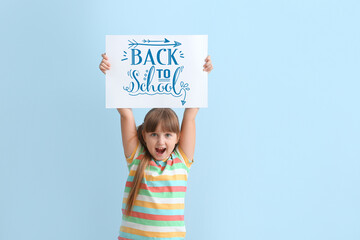 Sticker - Happy little girl holding poster with text BACK TO SCHOOL on light blue background