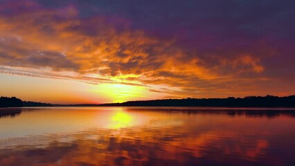 Wall Mural - Spectacular red dawn sky mirrored in tranquil waters, dynamic moving perspective.

