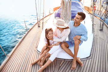 Canvas Print - Happy young family resting on yacht