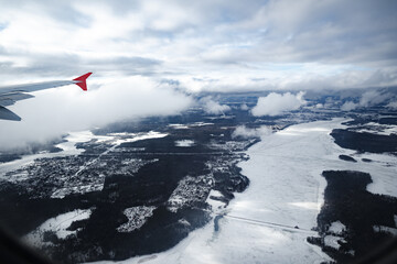 Wall Mural - aircraft wing above beautiful clouds and blue sky