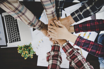 Canvas Print - young business people putting their hands together