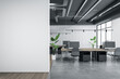 Front view on blank light grey wall with place for your logo or text in spacious industrial style coworking office with concrete floor, cozy workspaces and green plants. 3D rendering, mock up