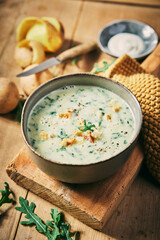 Tasty rucola soup on wooden board