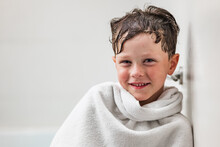 Positive Boy Wrapped In White Towel After Bathing