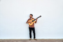 Cheerful Man Playing Acoustic Guitar