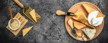 Parmesan. Cheeses Set Dor Blu Chedar Camamber Brie. Different Types Of Cheese With Knife On A Dark Background. Long Banner Format. Top View
