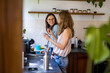 © pikselstock - Two women spending time in the kitchen at home