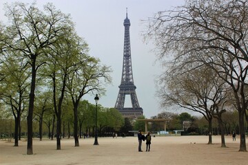 Couple in front of Eiffel Tower (Tour Eiffel). Paris, France