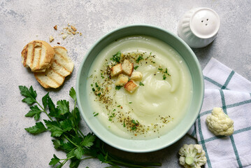 Wall Mural - Vegetarian cauliflower cream soup with croutons. Top view with copy space.