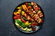 Chicken kebab skewers with grilled vegetables. Top view with copy space.