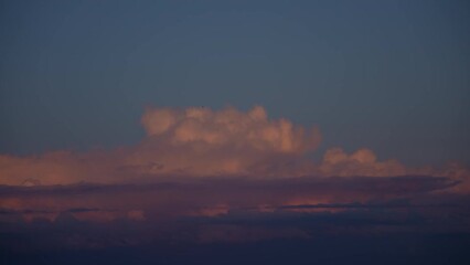 Wall Mural - sunset evening cloudy sky. 4k video time lapse of beautiful huge fluffy pink and orange clouds flyin