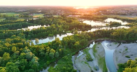 Wall Mural - A rocky river in the middle of a forest in 4K. Aerial view of tranquil river reflecting sky, amid lush green landscape, aerial view. Top view of a mountain river in the forest.