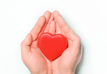 Sticker - Red heart in hands on white background. Healthcare and hospital medical concept,organ donation concept.Symbolic of Valentine day.Heart day.Сopy space.