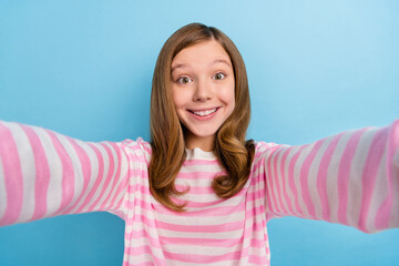 Wall Mural - Photo of cheerful friendly girl make selfie recording video beaming smile isolated on blue color background