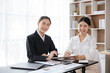 © aksonsat - Business women are smiling and looking at the camera in office space.