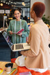 © Wavebreak Media - Smiling biracial female fashion designer showing discussing with colleague in studio