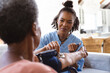 © Wavebreak Media - African american doctor examining senior patient's blood pressure with gauge and stethoscope at home