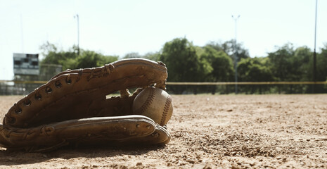 Canvas Print - Baseball glove with ball in field dirt for sports game concept.