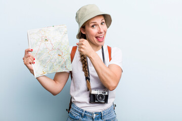 young adult blonde woman. tourist with a map concept