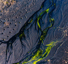 Texture Of Fiery Streams Of Metal On Background Of Black Texture, Different Colors In Fantastic Texture. Aerial View From Drone