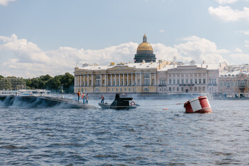 View of the nuclear submarine in the waters of the Neva against the background of St. Isaac's Cathedral. Exhaust fumes and smoke from the boat. Missile submarine. Russia, St. Petersburg, 30.07.2021