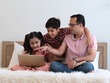 © Dollydoll - Indian father with two teenage son and daughter together at home using laptop for movie,  homework, online learning. Happy family, single father , education or father's day concept.