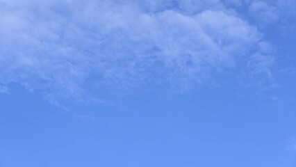 Wall Mural - blue sky with clouds timelape of dramatic fast moving white clouds on beautiful sunny blue sky
