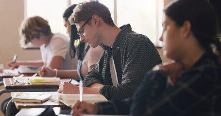 Aufkleber - An A+ coming right up. Shot of teenagers writing an exam in a classroom.
