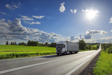 Wall Mural - Landscape with a moving truck on the highway at sunset