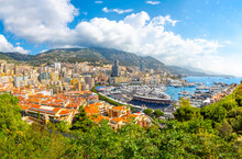 Panoramic view from the Rock of Monaco of the city of Monte Carlo, Monaco, the harbor port, mountains and city with the streets converted to race course on Grand Prix day.