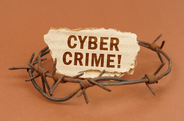 Aufkleber - On a brown surface, barbed wire and a cardboard sign with the inscription - Cyber Crime