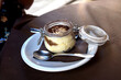Italian tiramisu dessert in a glass jar, served in cafe