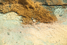 Wet Sand On Asphalt. Sand Lies On Ground.