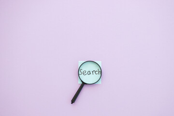 Wall Mural - magnifying glass on violet background. Search concept