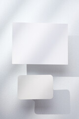 Leinwandbilder - blank poster card with product display stand with sunlight in white studio