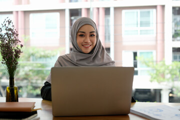 Wall Mural - Portrait asian muslim woman manager working with laptop computer.