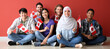 © Pixel-Shot - Group of students with Canadian flags sitting near red wall