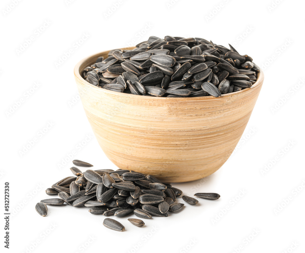 Bowl of black sunflower seeds on white background