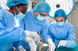 © Graphicroyalty - Surgeon team in uniform performs an operation on a patient at a cardiac surgery clinic. Modern medicine, a professional team of surgeons, health.