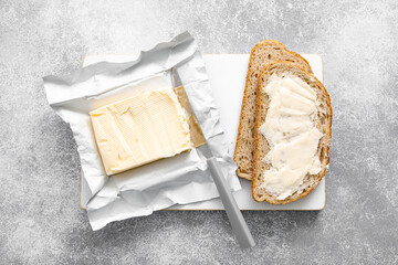 Poster - Block of butter with butter knife in a open pack.  Buttering bread