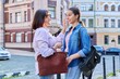 © Valerii Honcharuk - Talking mom and teenage daughter outdoors, on city street
