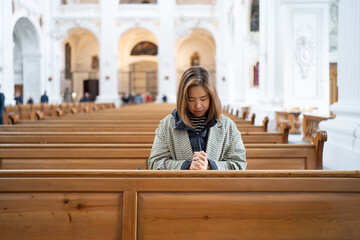 Wall Mural - A Christian female is sitting and praying.