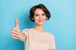 © deagreez - Photo of lovely cheery woman show you thumb up give compliment promote product isolated on blue color background
