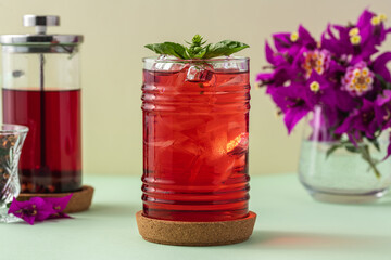 Wall Mural - Freshly brewed iced red fruit tea on green table